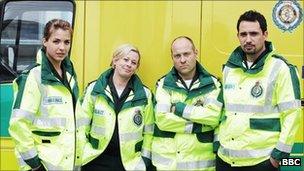 BBC Casualty paramedics standing in front of an ambulance