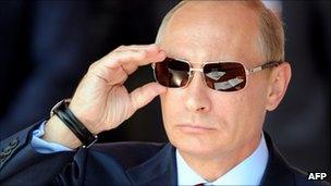 Russian Prime Minister Vladimir Putin adjusts his sunglasses at a Moscow air show, 17 August