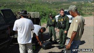 US border patrol officers stopping men to check their identification near the border of Texas and Mexico