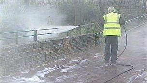 Council worker disinfecting footpaths in Bournemouth Lower Gardens