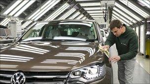 Volkswagen worker polishing car
