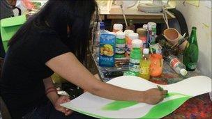 Young woman painting headdresses