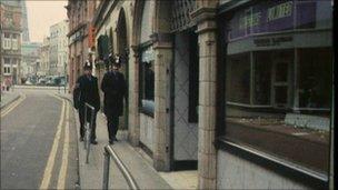 Police officers walking past the raided Blackpool jewellers