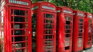 A row of red telephone boxes in central London