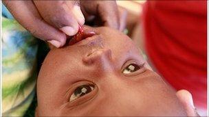 Child being given vitamin A tablet