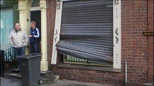 Damage to the shutters of a business in Manchester's Northern Quarter