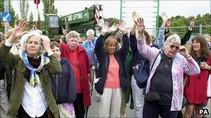 Peace camp members watch the last caravan leave in September 2000