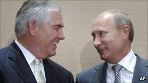 Exxon Mobil boss Rex Tillerson shakes hands with Prime Minister Vladimir Putin in Sochi