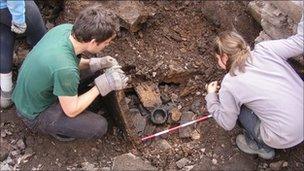 Serf archaeologists excavate the broch