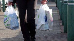 Someone carrying their shopping back to the car at the supermarket