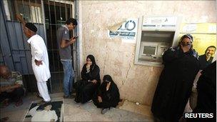 People waiting outside a Tripoli bank