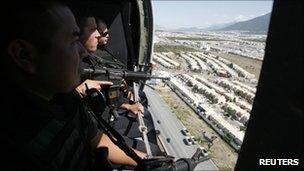 Federal police in a helicopter patrol Monterrey on 29 August 2011