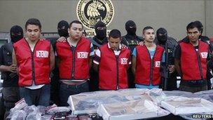 State investigations agents escort five men arrested in connection with an attack on a casino during a presentation in Monterrey 30 August 2011