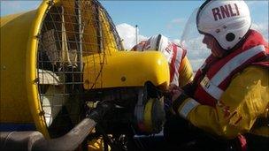 RNLI crew members Tom Stuart and Nicki Bignell attending to the hovercraft