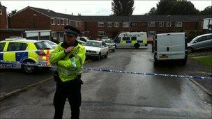 A police officer outside the house in Thame