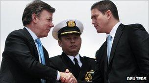 Colombian President Juan Manuel Santos shakes hands with new defence minister Juan Carlos Pinzon