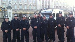 Some of the officers (with their Welsh branded van in the background) outside Buckingham Palace