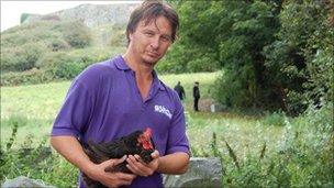 Geoff George holding a chicken