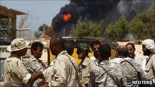 Rebels outside an oil refinery