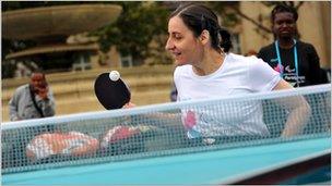 Athletes play table tennis