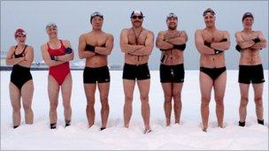 Swimmers stand in the snow on Brighton beach in December 2010