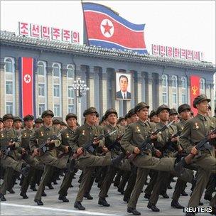 North Korean soldiers parade in front a portrait of former North Korean President Kim Il-sung during a military parade in Pyongyang