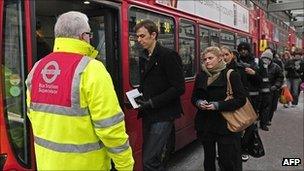 Passengers board a London bus