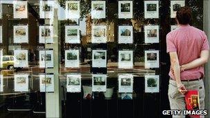 Man standing outside estate agent