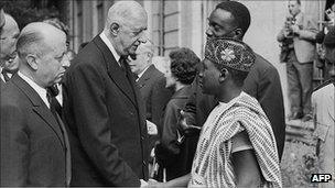 Jacques Foccart (L) and French President General Charles De Gaulle greet African veterans in Paris