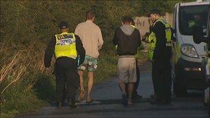 Men being led away by police