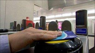 Woman swiping an Oyster travel card