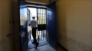 A prison officer stands by a door at Wormwood Scrubs