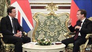 British Prime Minister David Cameron (left) and Russia's President Dmitry Medvedev talk during their meeting in Moscow