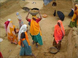 Women digging ditches for water storage