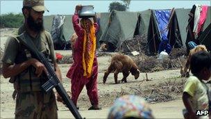 A Pakistani army soldier stands at a flood affected makeshift camp in Khoski Goth in the Badin district, some 140km east of Karachi on August 18, 2011