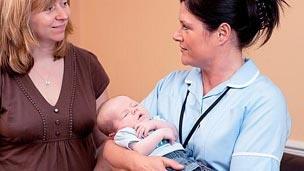 Midwife with mother and baby