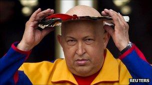 President Hugo Chavez wearing a feathered indigenous head dress