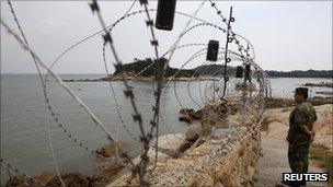 A soldier stands guard in Kinmen, one of Taiwan's offshore islands, on 22 August 2011