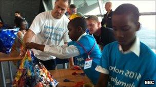 Children from Hackney Schools and Paralympic gold medal swimmer David Roberts make lanterns for a procession ahead of the relay announcement