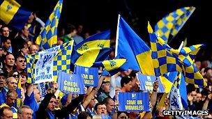 AFC Wimbledon supporters cheer on their team