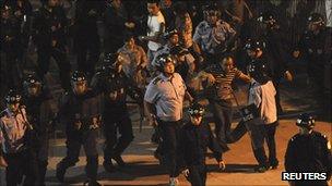 Riot police remove protesters from outside the entrance to the Zhejiang Jinko Solar Co in Haining, Zhejiang province, on 17 September 2011