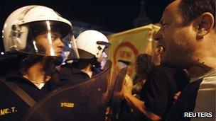 An anti-austerity protester shouts at police officers outside the Greek parliament 18/9/2011