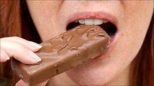 woman eating a chocolate bar