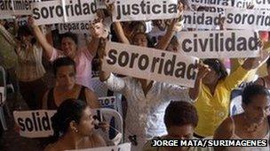 Women in Colombia hold up banners as part of a demonstration to call for justice for victims of sexual abuse in Barrancabermeja, 2007