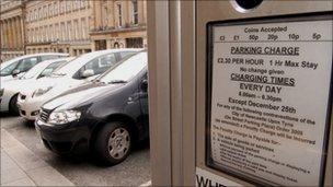 Parking meter with cars nearby