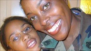 woman in military fatigues with her daughter