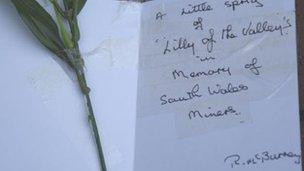 A card placed at the Gresford memorial in memory of the four men who died in the Gleision Colliery