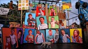 Children of Dale Farm travellers site hold pictures of themselves at the gate to the illegal travellers site in Cray's Hill, Essex