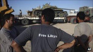 Former rebel fighters next to a tank in southern Libya, 21 September 2011