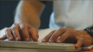 Person typing on a keyboard